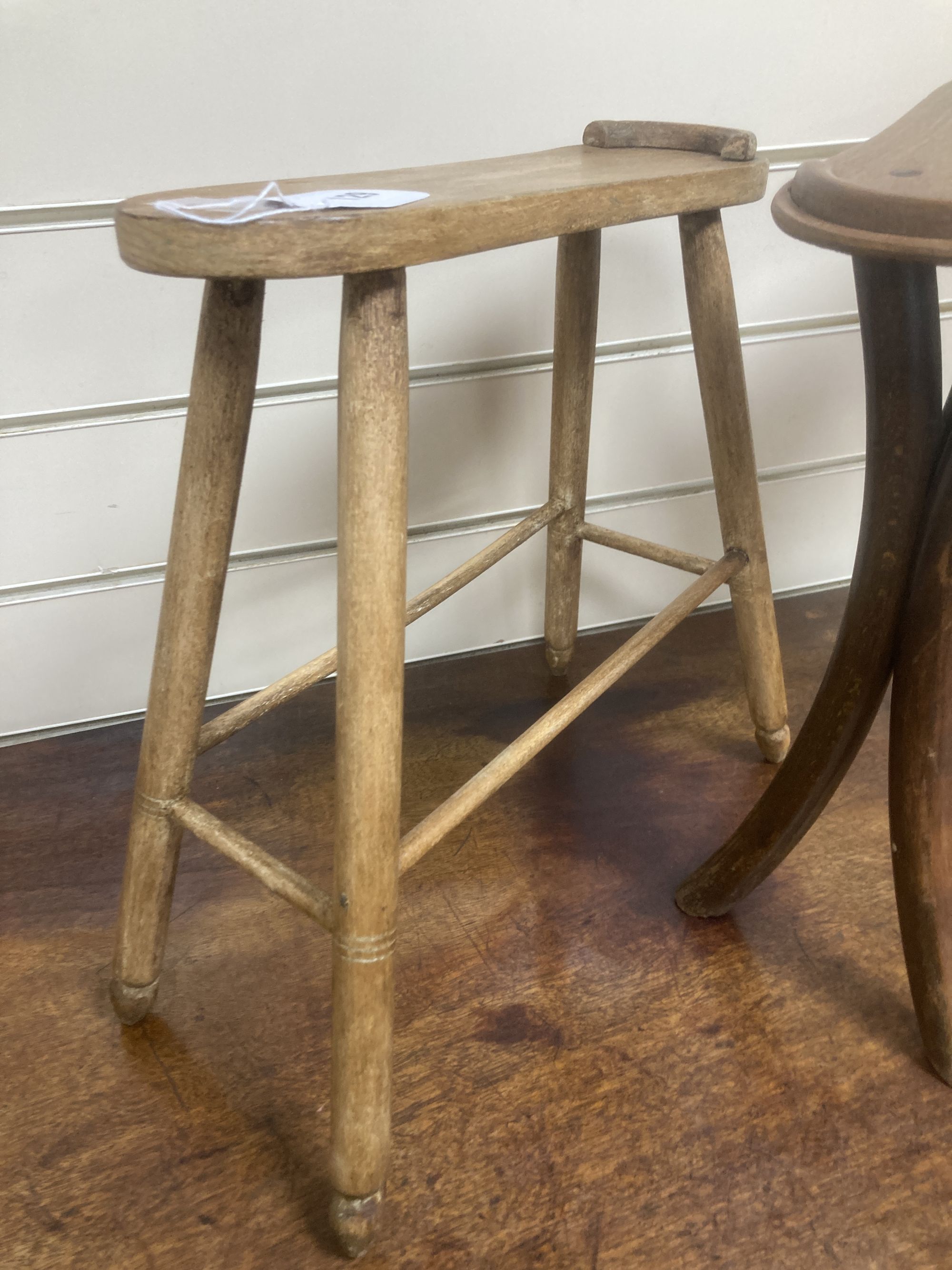 Two early 20th century treen shoe rests, larger 36cm wide, 35cm high
